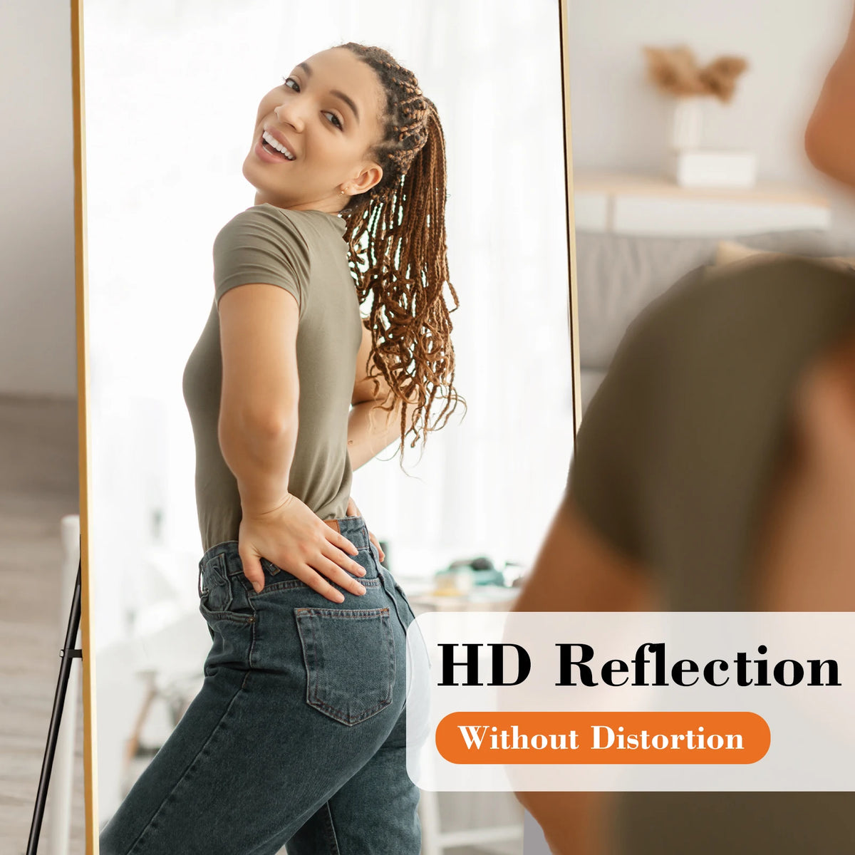 A woman is reflected in a full length floor mirror, showing her full body and clothing.