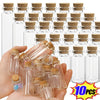 A hand holds a collection of small glass vials with cork stoppers, showing various sizes and clear glass.
