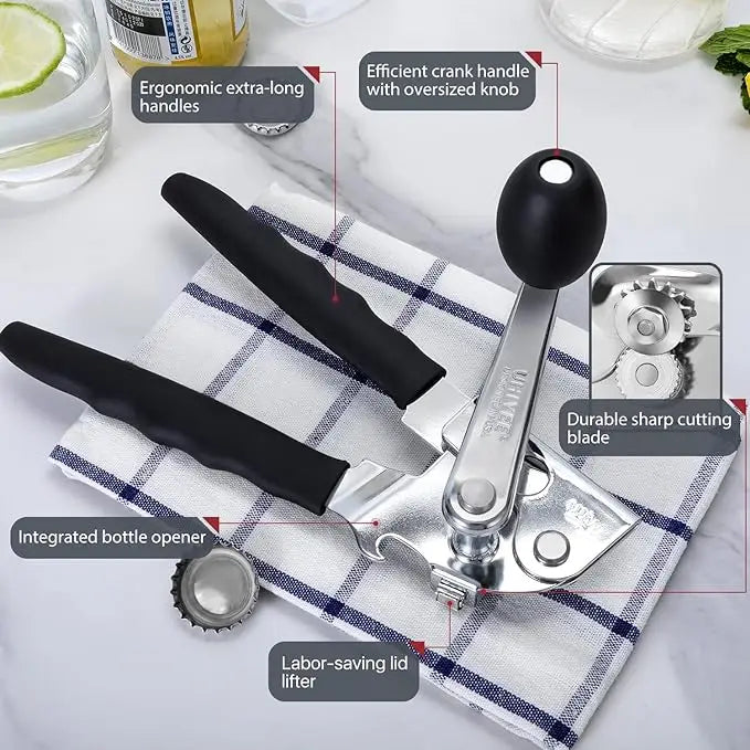A silver manual can opener with a black handle and oversized knob, shown next to a cloth napkin.