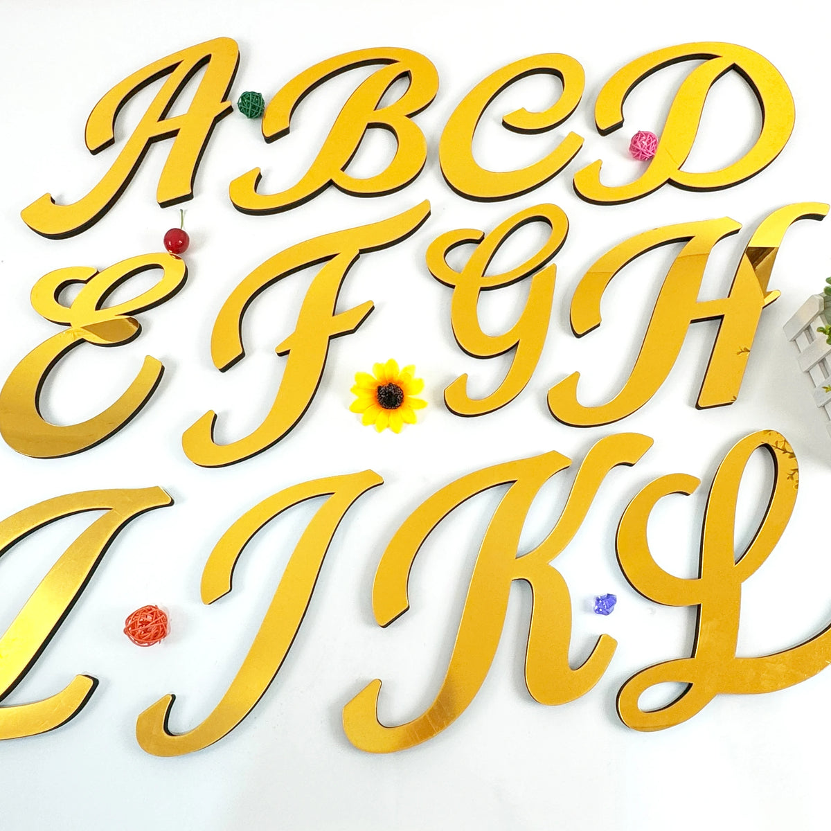 A to L gold 3D acrylic letter wall stickers displayed on a white background