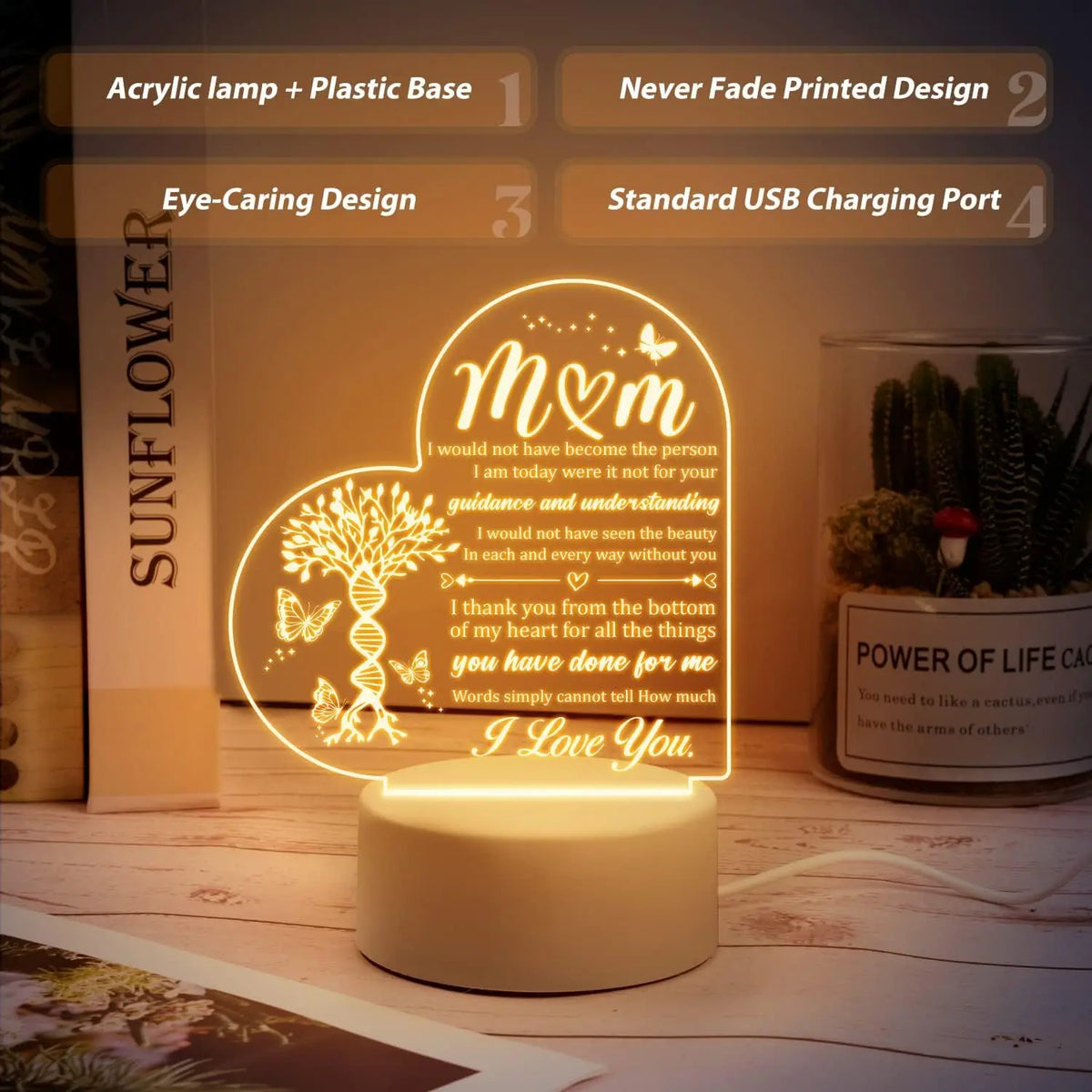 A glowing acrylic night light featuring a heart design with the text I love you on a wooden surface.