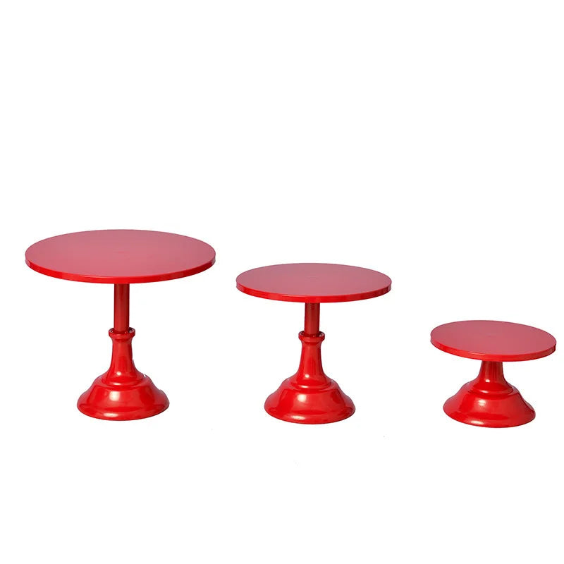 A set of three bright red metal cake stands for dessert display or afternoon tea.
