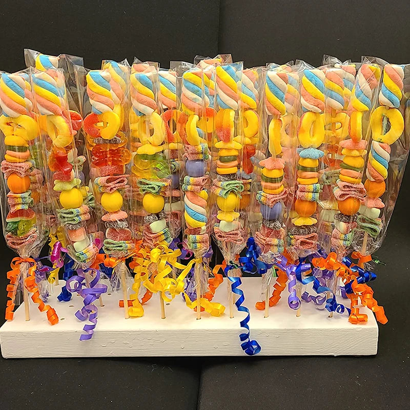 Clear cellophane gift bags filled with colorful candies and treats arranged vertically.