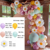 A colorful balloon garland kit featuring various shades of pink, yellow, purple, and green balloons arranged in a floral desi