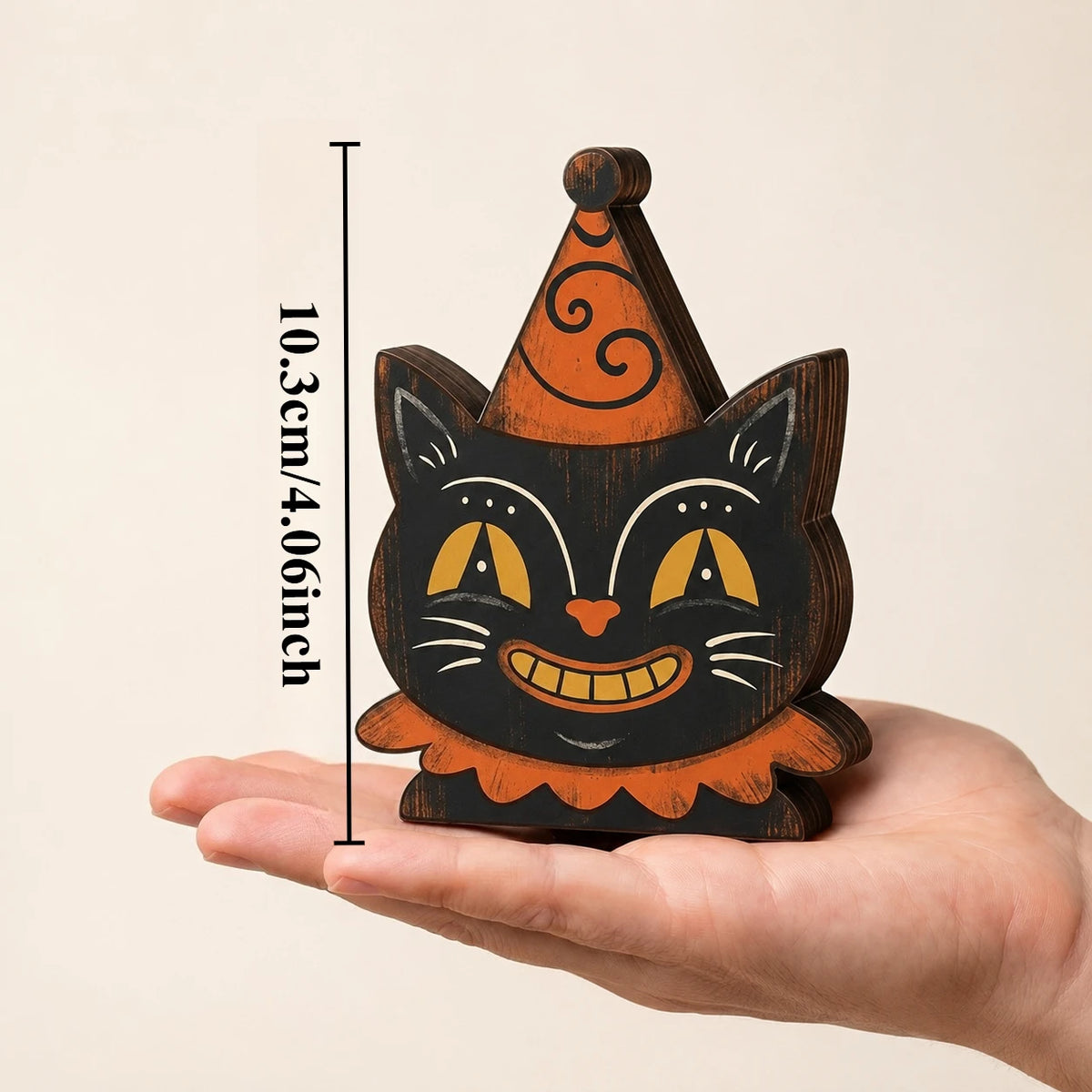 A wooden block Halloween decor set shaped like a cat with orange and black paint on a light background.