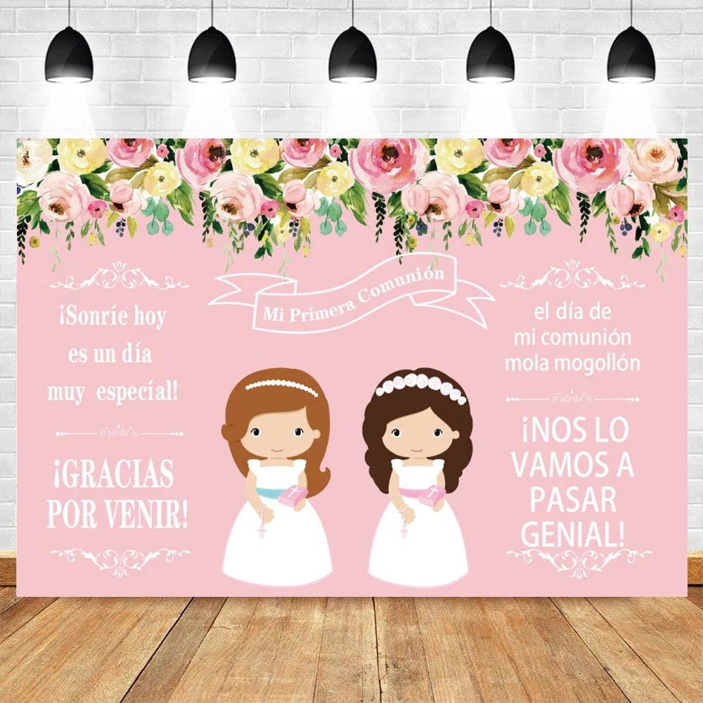 A pink and green floral backdrop for a First Communion celebration featuring two girls in white dresses