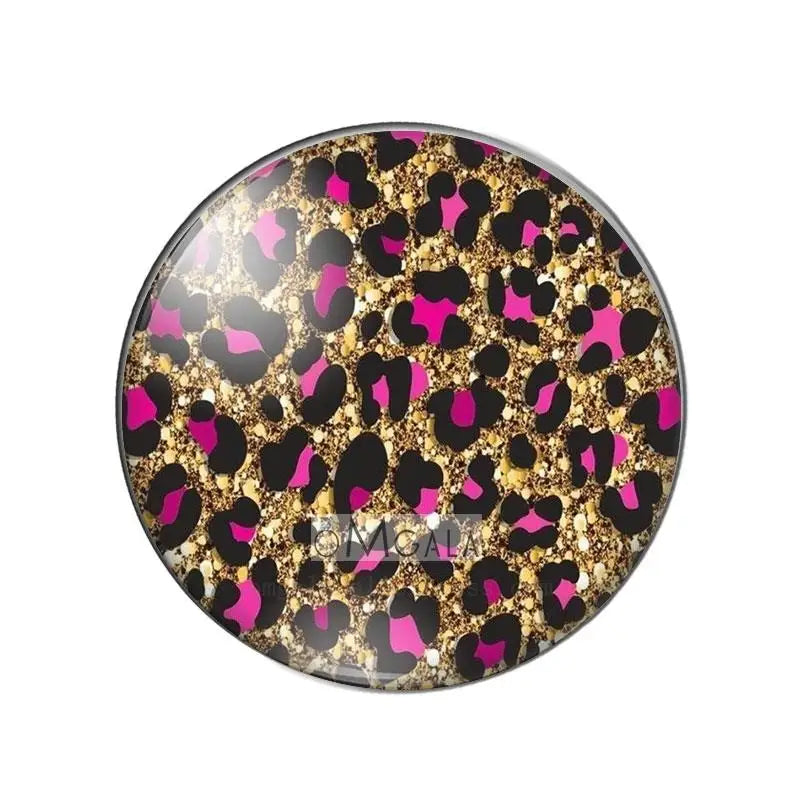 Round glass cabochon with a leopard print design featuring black and gold elements.