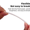 A hand is holding a white, flexible food paper stick for cake pops or candy making.