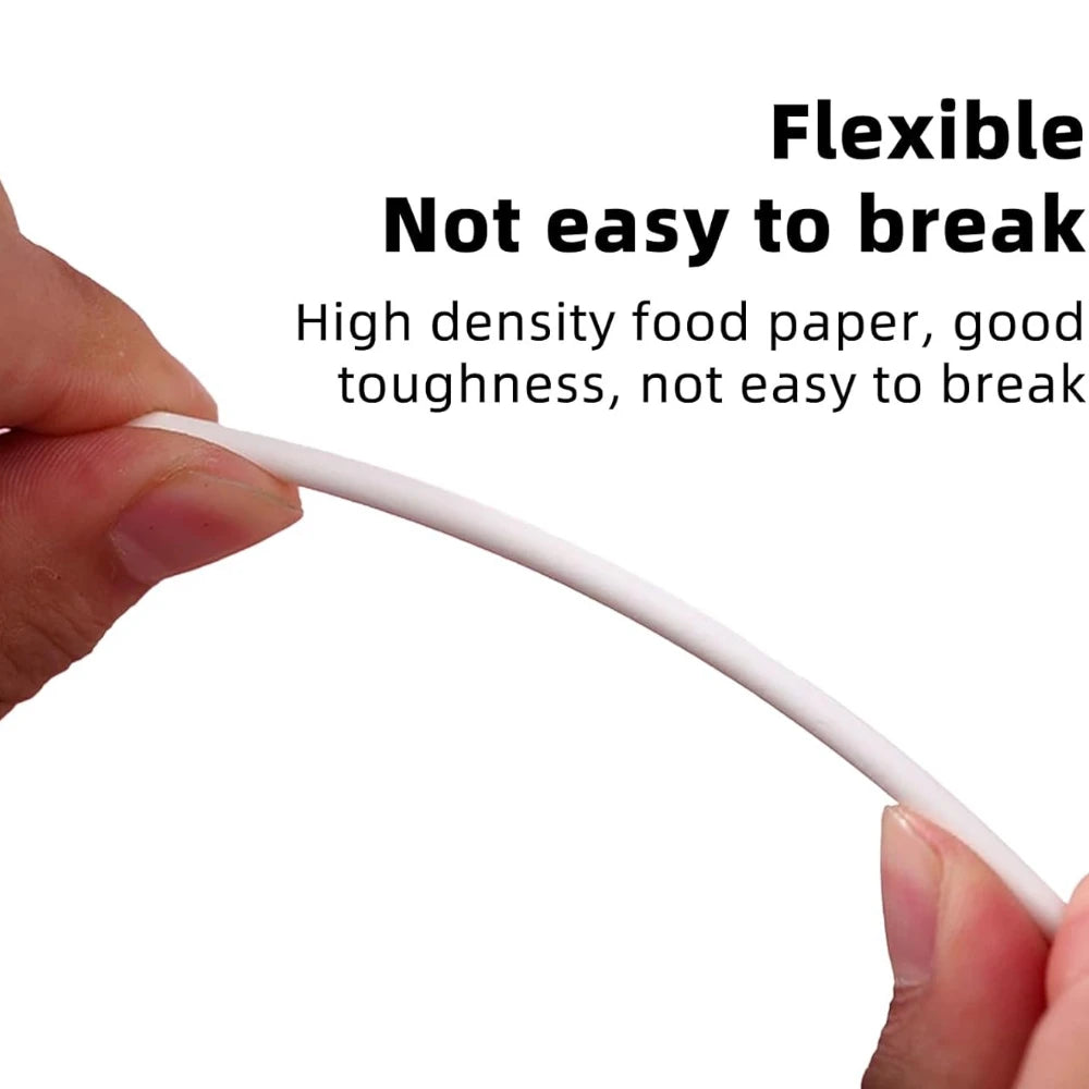 A hand is holding a white, flexible food paper stick for cake pops or candy making.