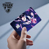 A hand holds a Dragon Ball Super Saiyan card skin sticker featuring a fierce character design against a dark purple backgroun