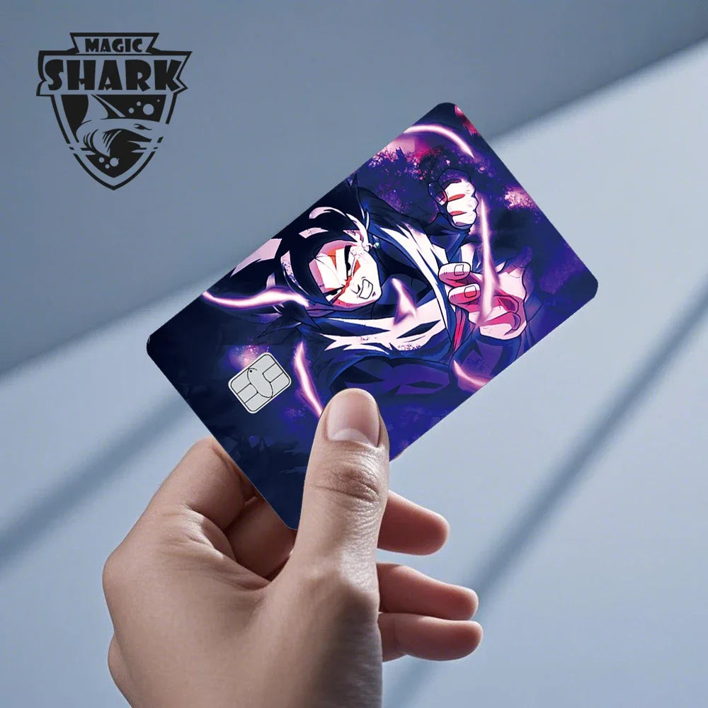 A hand holds a Dragon Ball Super Saiyan card skin sticker featuring a fierce character design against a dark purple backgroun