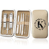 An open leather case displaying an 8-piece stainless steel manicure and pedicure kit with various tools.