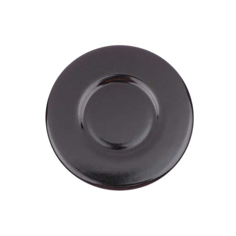 A round, dark, black gas stove burner cap or lid.