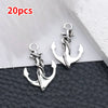 20 pieces of silver vintage ship anchor charms for jewelry making displayed on black leather.