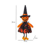 A black witch hat with an orange face and a black dress featuring orange accents and yellow boots.