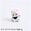A small white resin cat keychain with pink accents and a black collar.