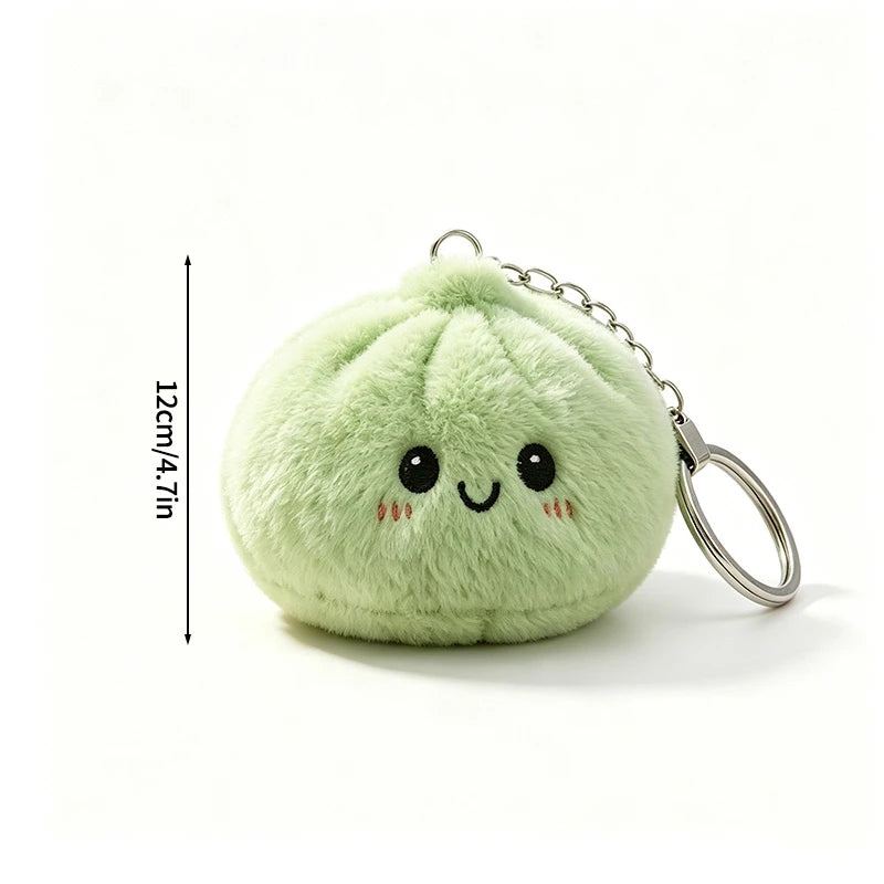 A light green plush butter dumpling squishy keychain with a smiling face and silver keyring.