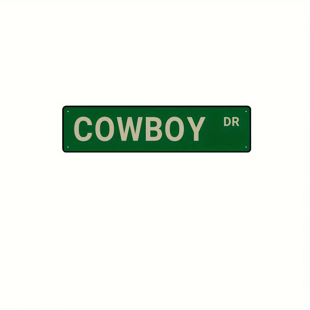 A rectangular green metal sign with the word COWBOY and the letters DR on it.