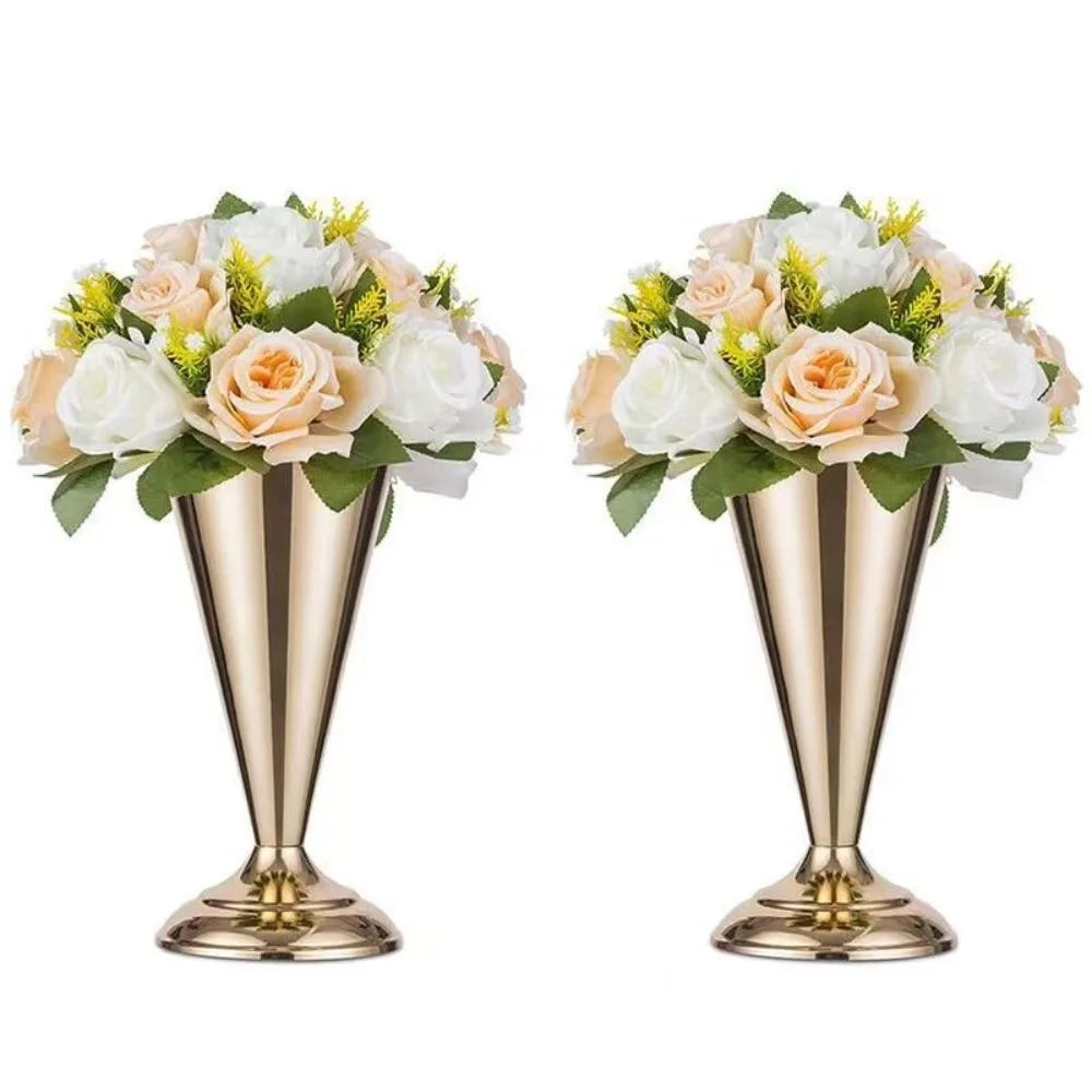 Elegant golden silver wedding flower vases filled with white and peach roses and greenery