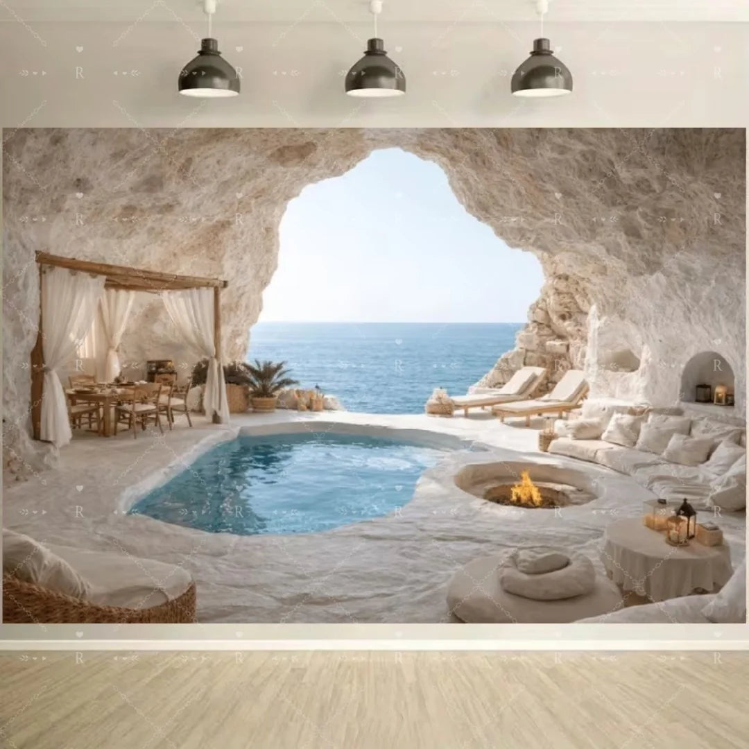 A natural rock archway frames a blue swimming pool and lounge area overlooking the sea.