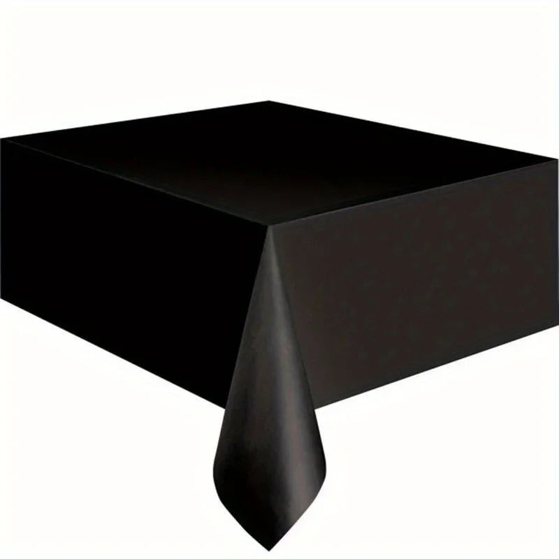 A black disposable solid color tablecloth draped over a table.