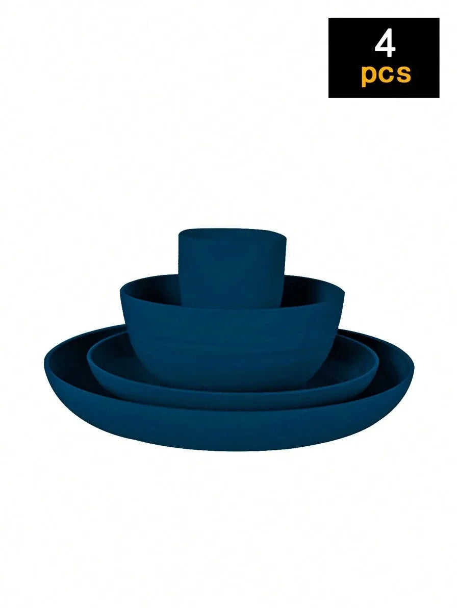 A set of four dark blue reusable plastic tableware items including a bowl and three plates.
