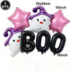 Pink ghost shaped balloons and black letter balloons spelling BOO for a Halloween party