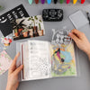 A clear A6 storage album with 40 pages is shown open, displaying various craft supplies and photos.