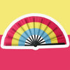 A colorful folding hand fan displaying a rainbow pattern against a yellow background.