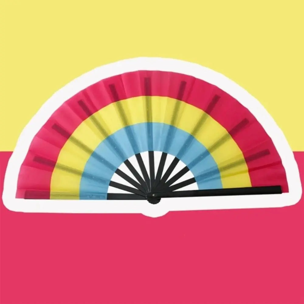 A colorful folding hand fan displaying a rainbow pattern against a yellow background.