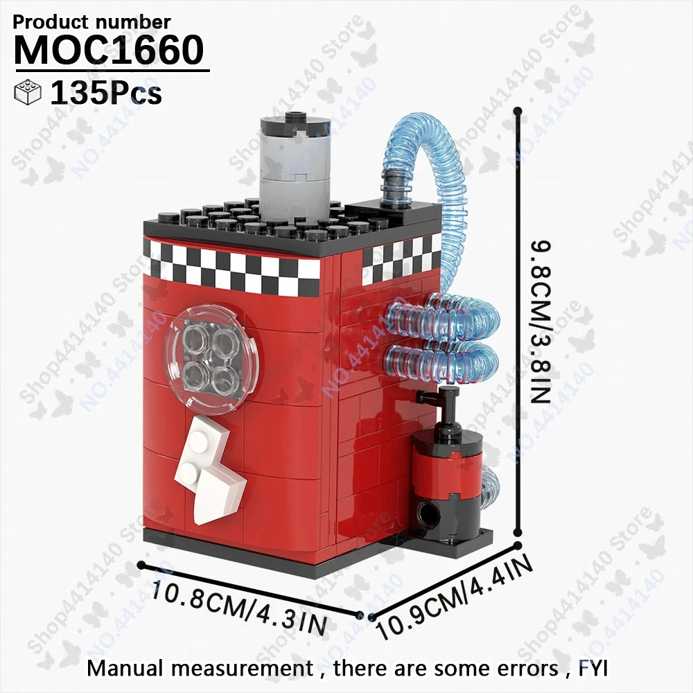 A red building block model of a structure with a cylindrical top and pipes, shown next to a ruler for scale.