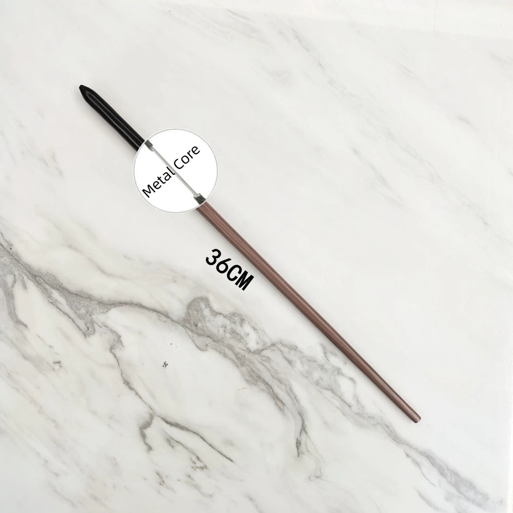 A long, slender metal wand replica with a circular metal core is displayed on a white marble surface.