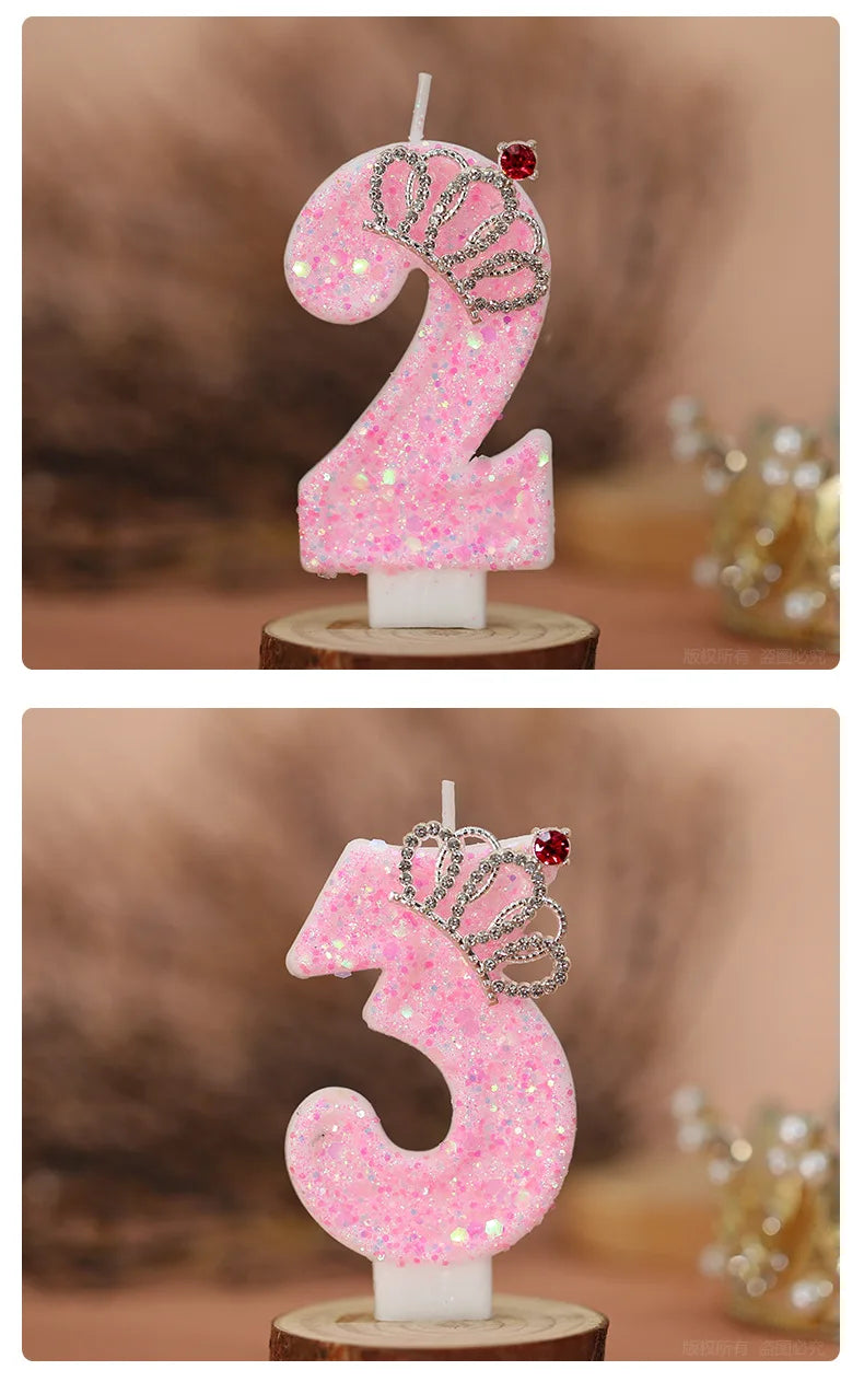 Pink glitter birthday candles shaped like the numbers 2 and 3 with crown designs