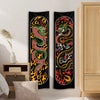 Black flame serpent vertical tapestry wall hanging displayed on a white wall next to a wooden cabinet.