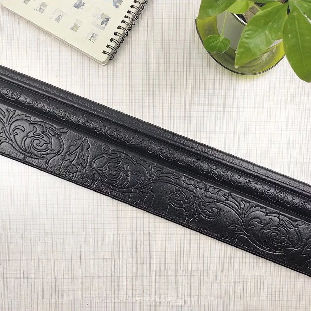 Black self-adhesive 3D wall trim line with ornate floral pattern for modern home decor