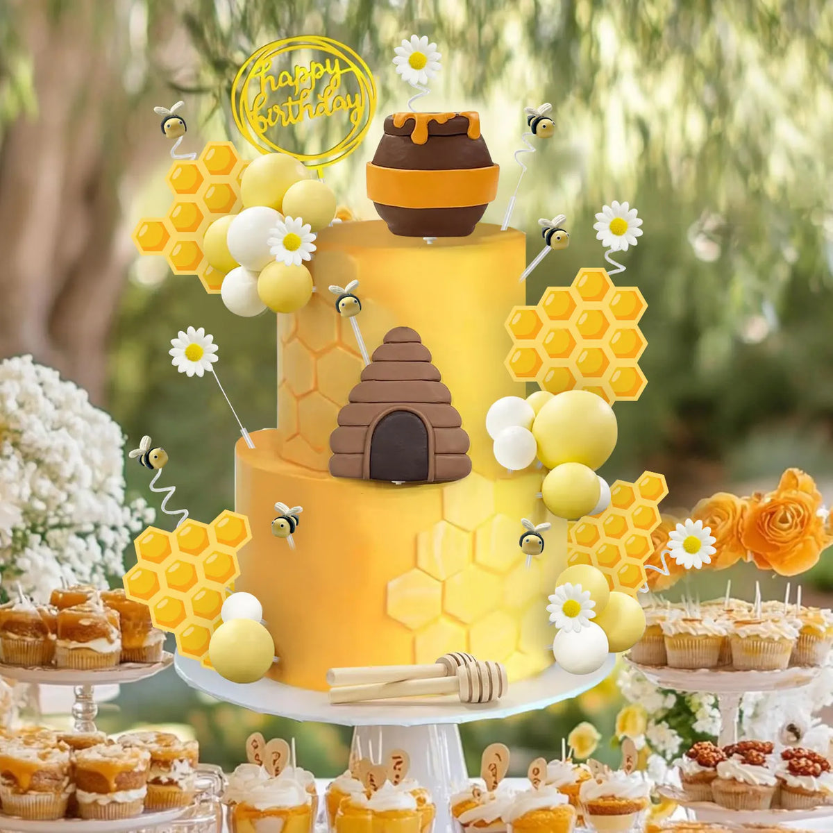A yellow birthday cake decorated with honeycomb shapes, white and yellow spheres, and a brown honey jar topper.