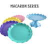 A collection of colorful plastic macaron series cake stands in purple, yellow, pink, and light blue.