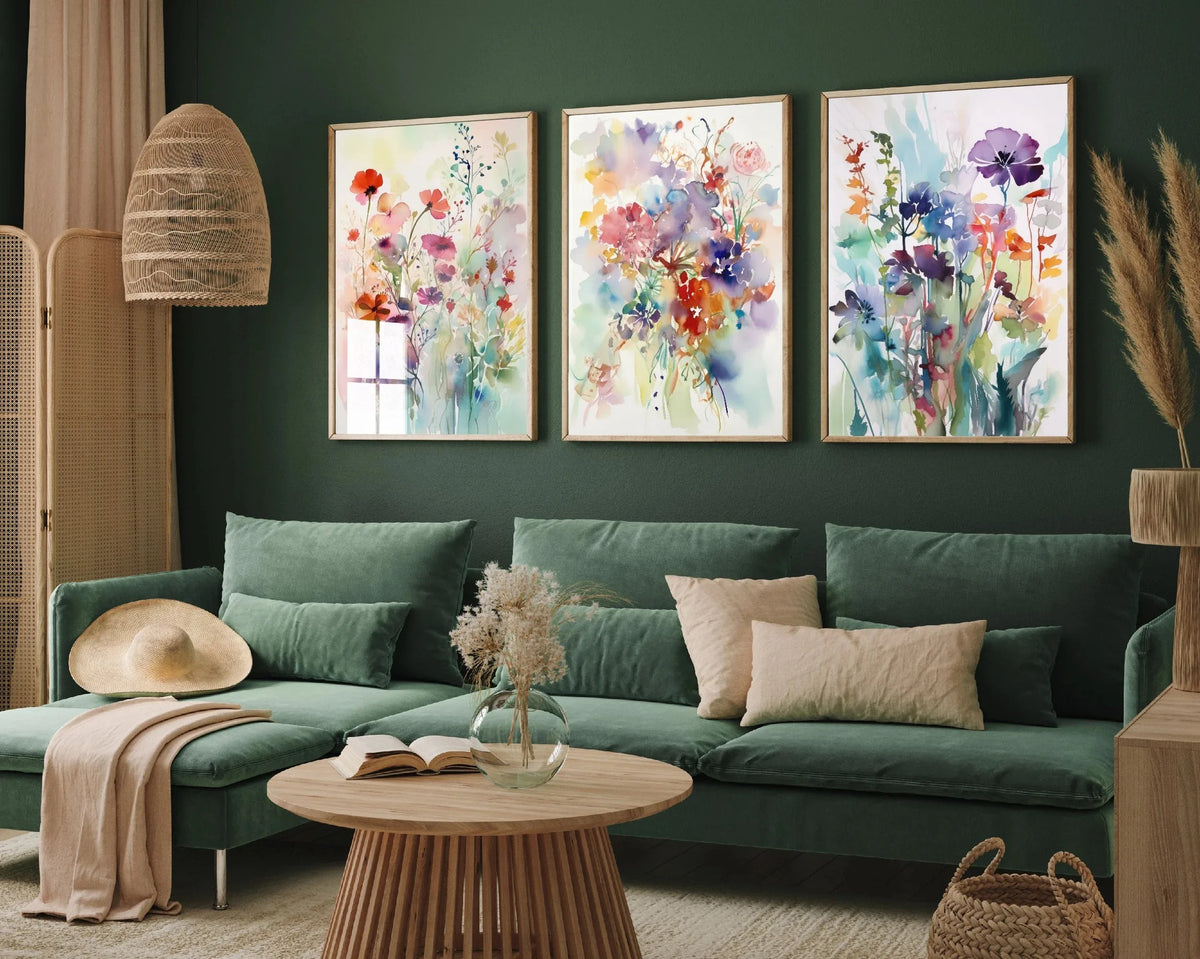 Three canvas prints featuring colorful retro wildflower landscapes displayed on a green sofa.