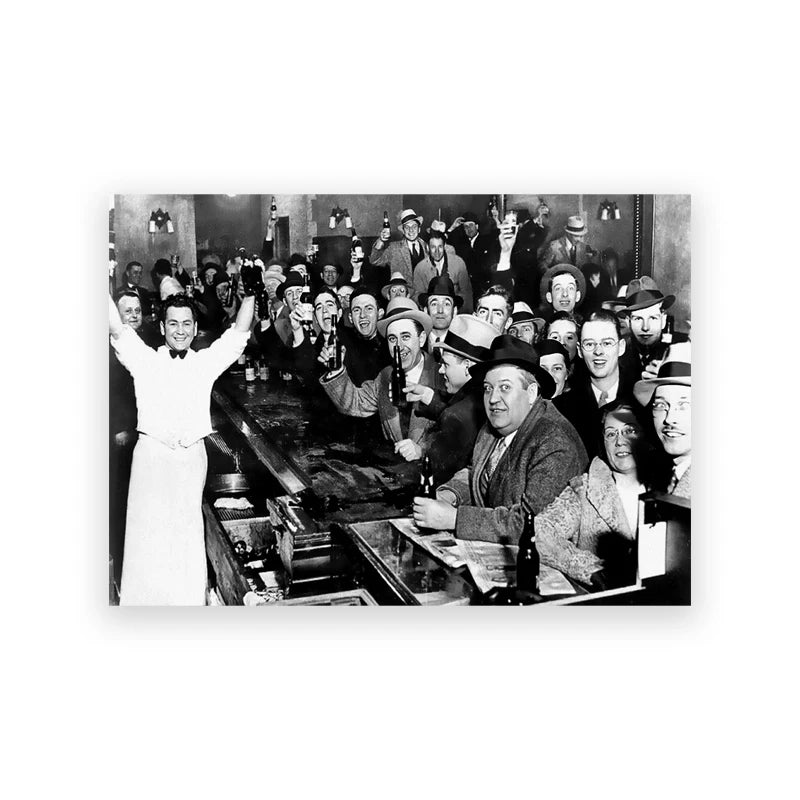Black and white photograph of a group of men in period attire gathered indoors.
