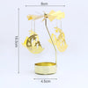 Gold rotating candle holder with a spinning carousel design and decorative stars and moons
