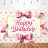 A pink checkered bow tie birthday party backdrop banner featuring a gold frame and pink confetti.