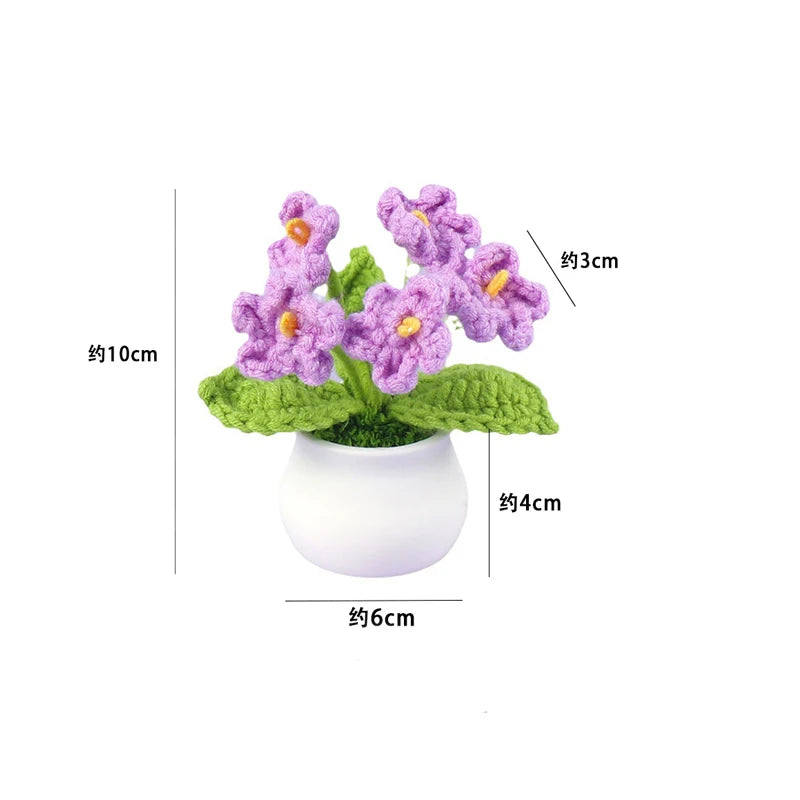 Hand woven purple crochet flowers in a green pot