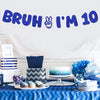 A blue banner spelling out Bruh I'm 10 is displayed above a table set for a birthday party.