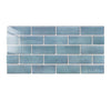 A rectangular mosaic of light blue glossy tile wall stickers arranged in a stacked brick pattern.