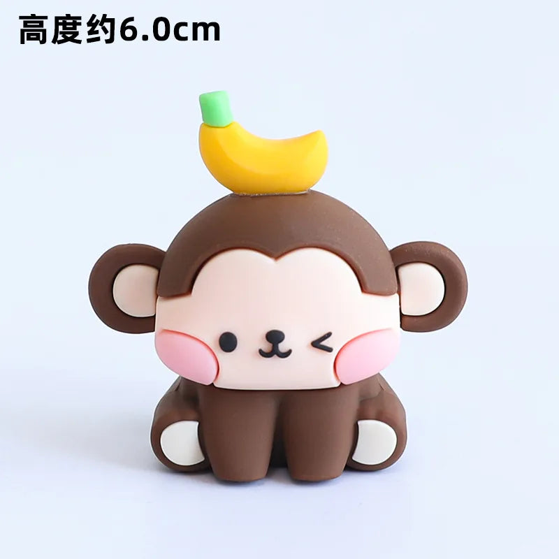 A cute, stylized monkey decoration with a yellow banana on its head, used for birthday decorations.
