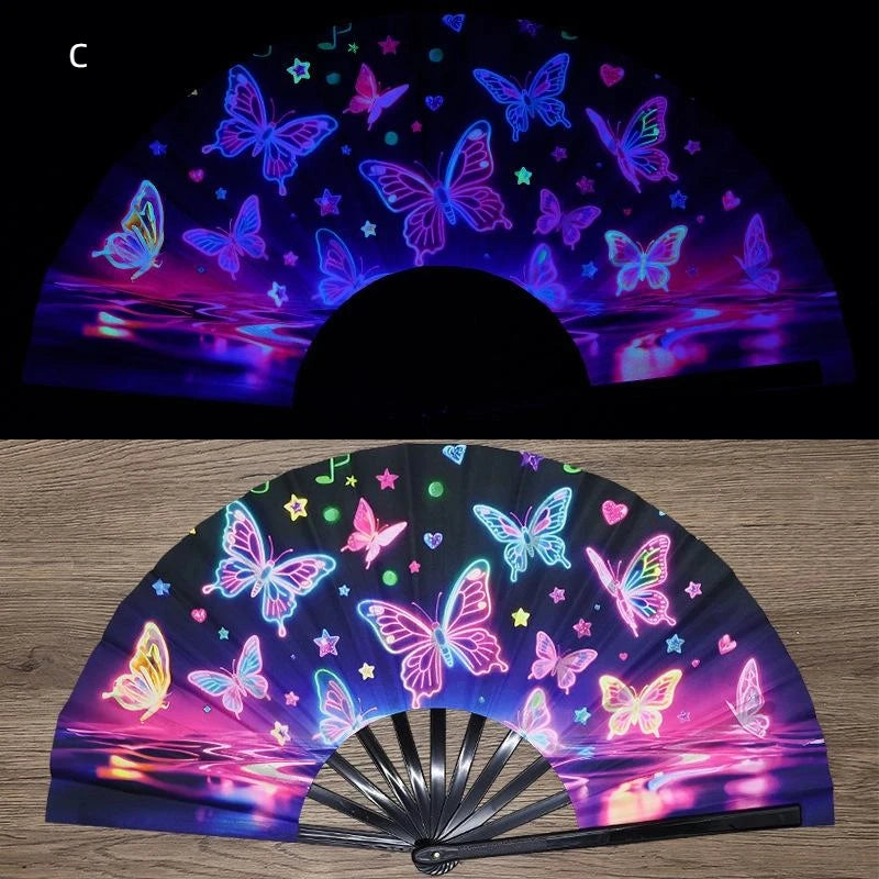 A folding fan with iridescent and fluorescent butterfly designs displayed under UV light.
