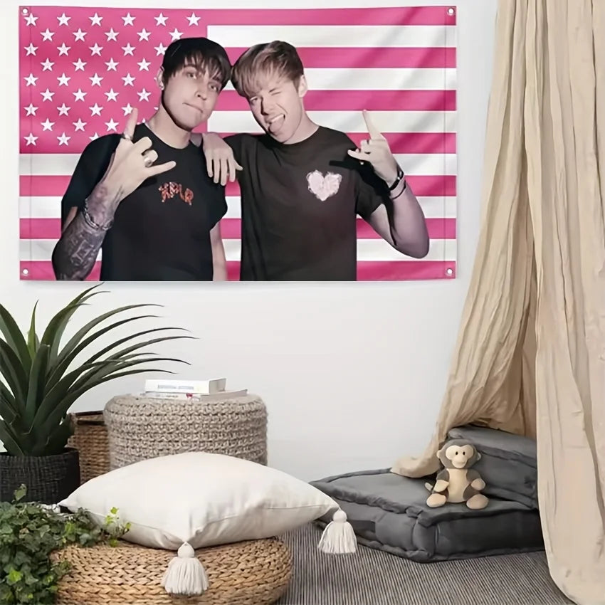A pink American flag tapestry featuring stars and stripes displayed on a wall.