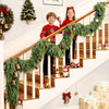 A festive Christmas scene featuring a wooden staircase decorated with a green cedar garland and children.