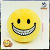 A yellow plush doll shaped like a smiling face with a wide white toothy grin.