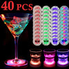 40 pieces of luminous LED coaster lights for bottles and glasses displayed alongside a martini glass and various drinking gla